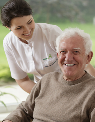 a hales care worker looking at her client smiling