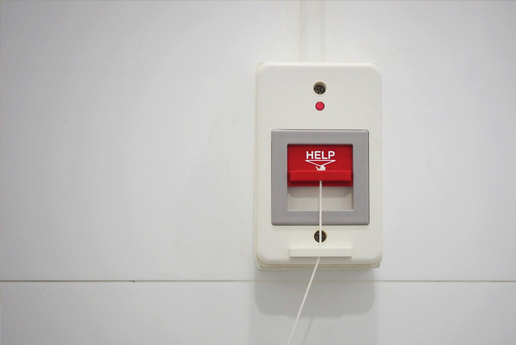 A red and grey emergency alarm device