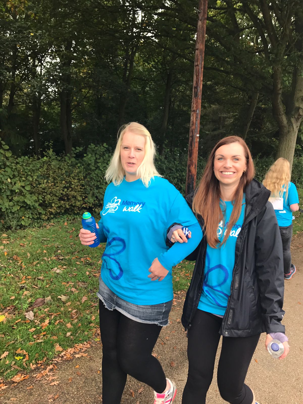 A group of women walking and wearing matching shirts for alzheimer's society memory walk