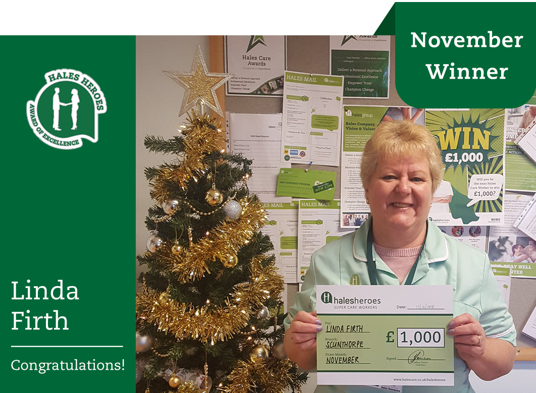 care worker linda holding a £1000 cheque from hales and a christmas tree