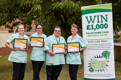 a group of female care workers holding a certificate