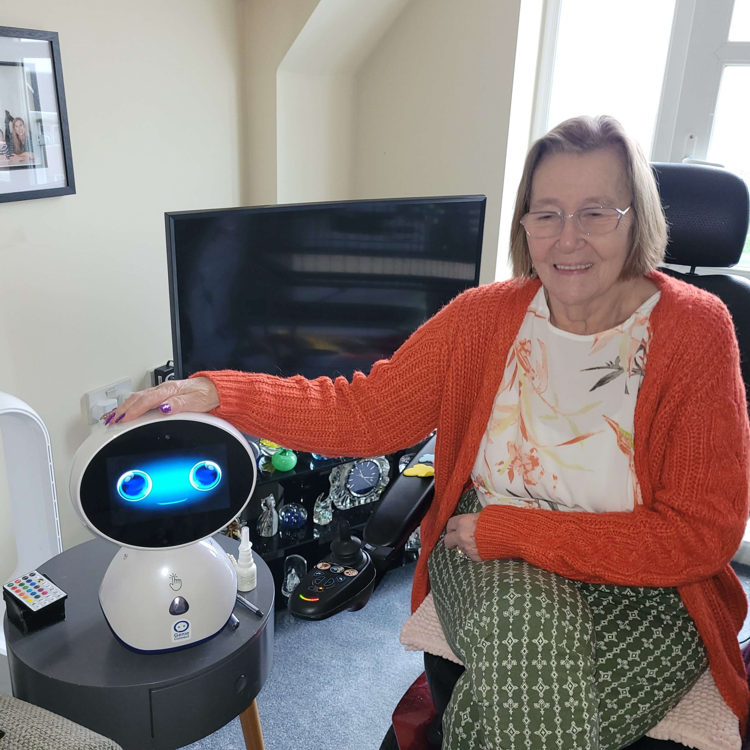 a photo of lynn, ashby meadows service user, with a robot